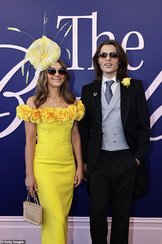 The Bedazzled actress fixed a huge yellow floral fascinator into her brunette tresses and shielded her eyes with a pair of round shades