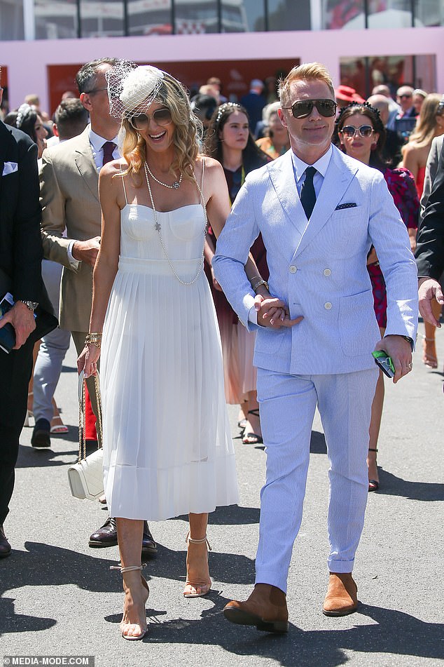 The Boyzone star, 47, who is performing at the Melbourne Cup Carnival, cut a suave figure in a white two-piece suit, which he styled with brown boots and a dark tie