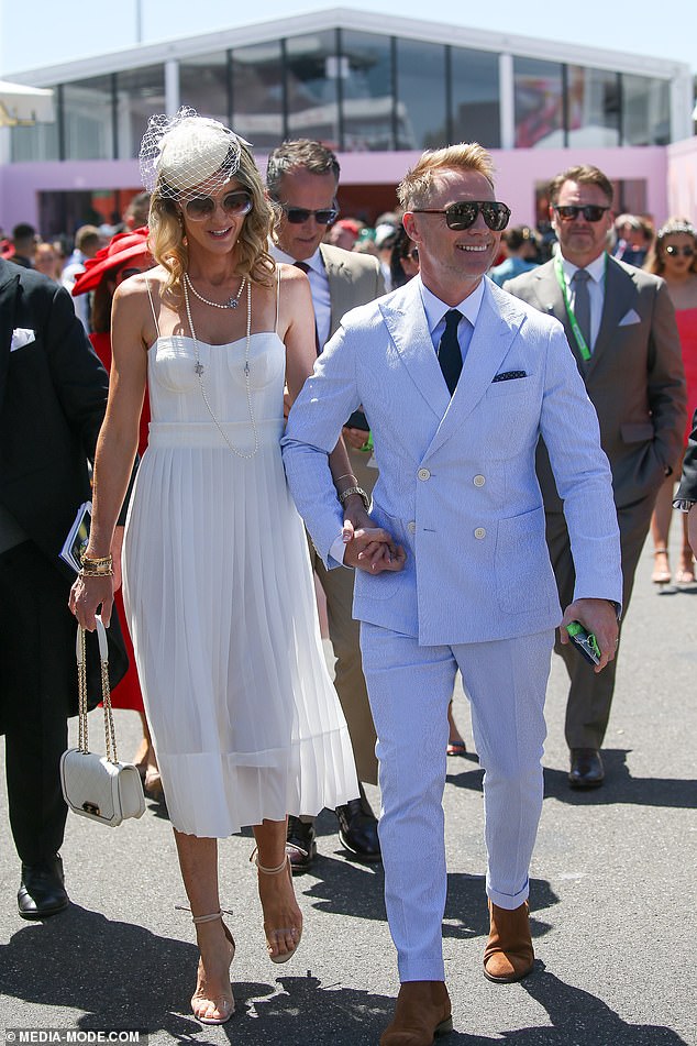 His wife Storm, 43, looked stylish as she stepped out in a white floating summer dress and pointed heels as she brought the glamour to the event