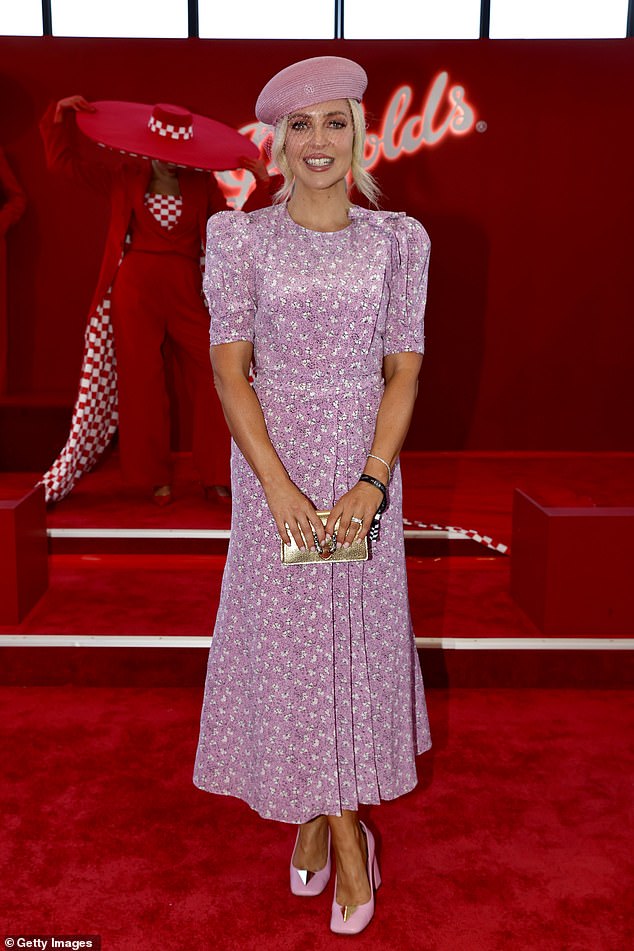 3AW football presenter Jacqueline Felgate looked pretty in pink as she sported a floral patterned dress and chunky heels