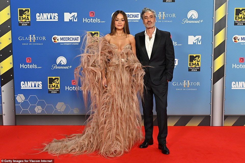 Having already made history as the first person to host the MTV European Music Awards for the third time, Rita Ora claimed the red carpet as her own as she arrived alongside husband Taika Waititi