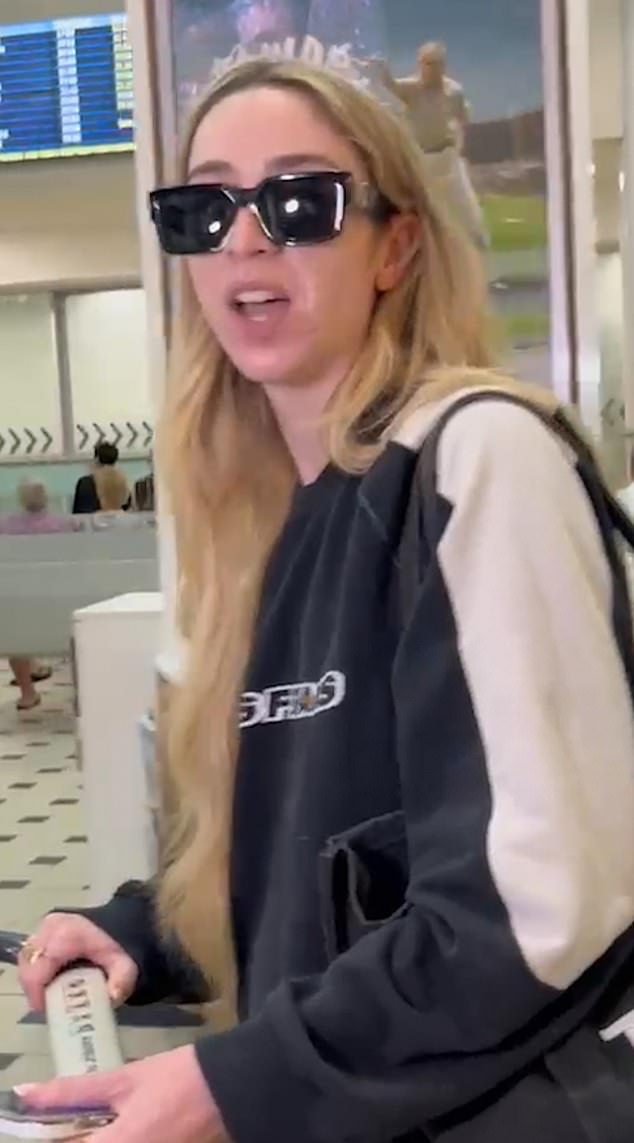 GK rocked a black and white tracksuit as she arrived in Oz