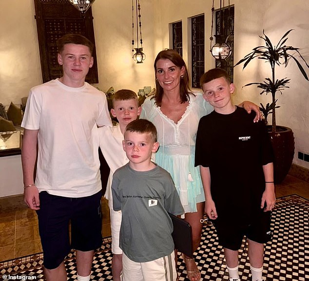 Coleen's necklace paid tribute to the four young sons (pictured) she shares with husband Wayne