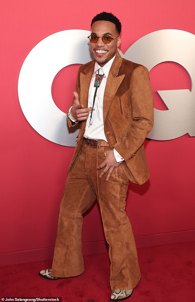 The rapper opted for a pair of snakeskin cowboy boots and also wore a white shirt with a bolo tie around the neckline