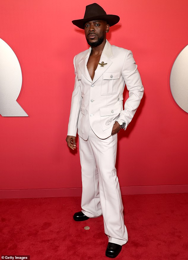 Adekunie Gold dressed to impress wearing a white suit that comprised of a fitted blazer and matching trousers