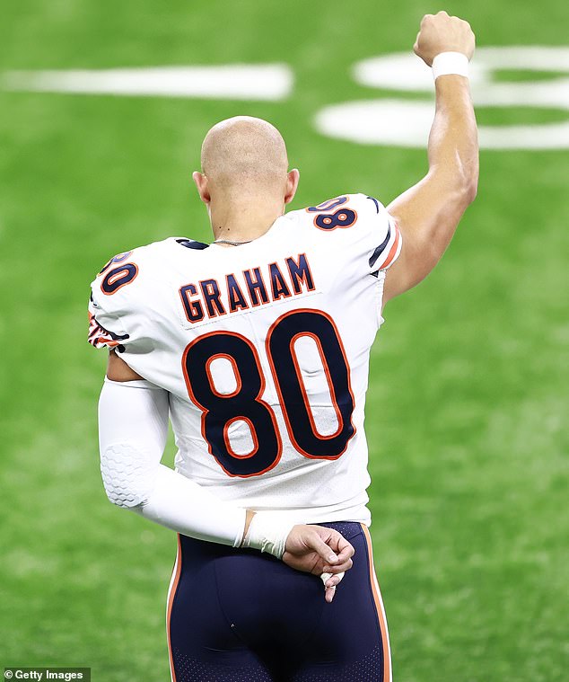 Tight end Jimmy Graham raises his fist during the national anthem before a game in 2020