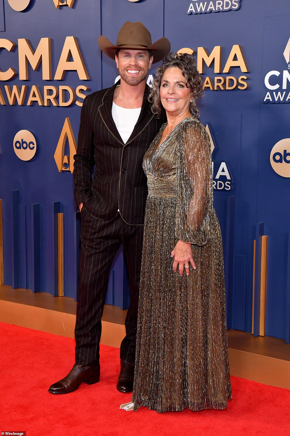 Dustin Lynch and Patti Lynch flashed bright smiles on the red carpet