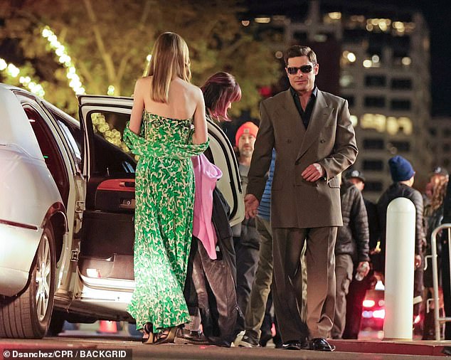 The pair emerged from a car to attend the event, with Zac sporting a dapper brown suit