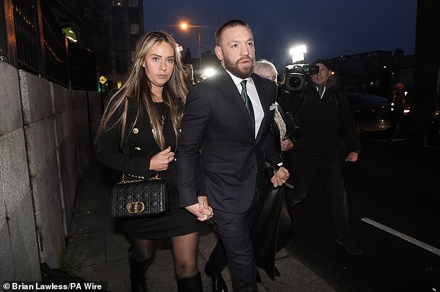 McGregor, pictured with his partner Dee Devlin at the High Court in Dublin this evening, faced an accusation that he 'brutally raped and battered' Nikita Hand