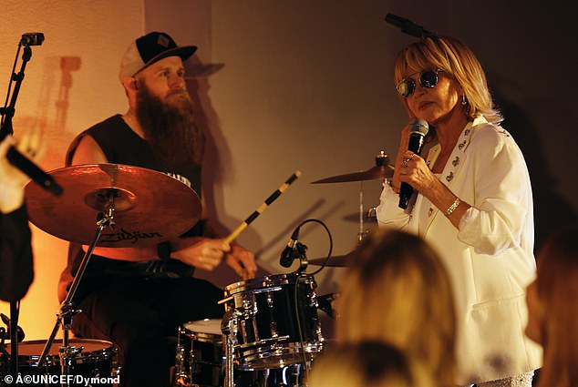 The Scottish singer-songwriter dazzled in a pair of embellished, white pants as well as a white shirt and blazer that contained sparkling details on the lapels