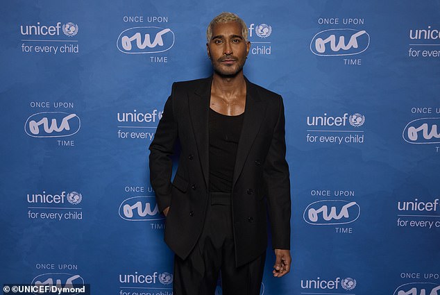 He additionally wore a plain, black tank top underneath and wore a pair of black shoes to complete the all-black outfit