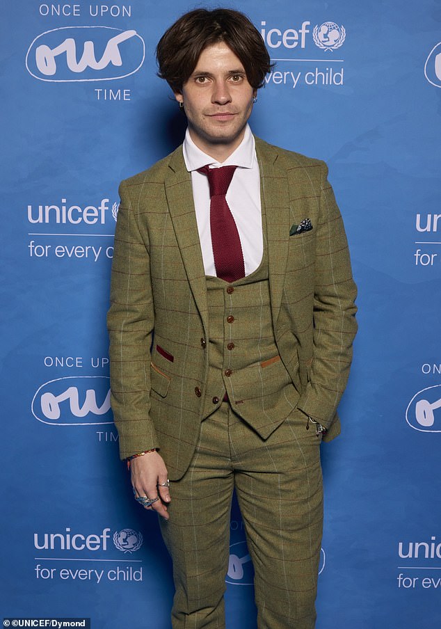 Cel Spellman was dapper wearing a green plaid suit as well as a matching vest and dark red tie