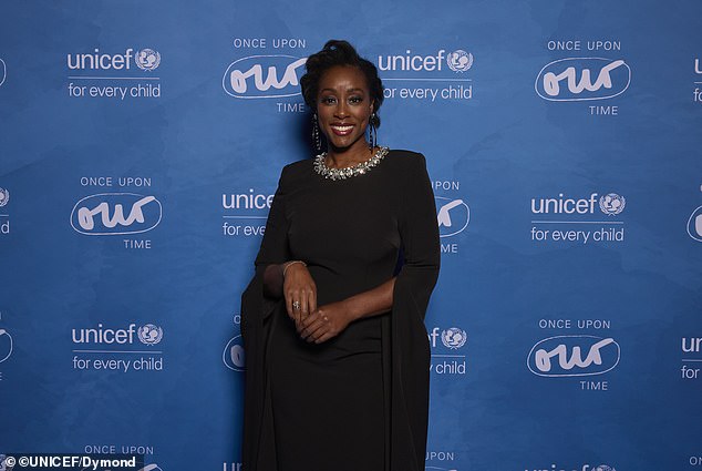 Scarlette Douglas was elegant wearing a black gown that contained draped sleeves as well as sparkling, rhinestone embellishments on the neckline