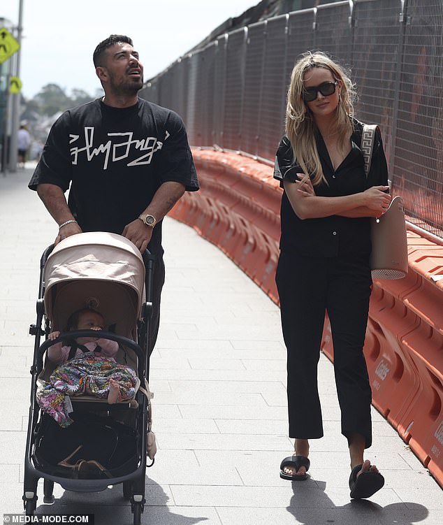 Two days later, Madeline's older - and, at one time, more famous - sister Simone is pictured stony-faced as she walks through Sydney with her ex-partner, celebrity trainer Jono Castano, who pushes their baby daughter Gia in a stroller. With her arms crossed defensively, the physical and emotional distance between the former couple is stark on their co-parenting outing