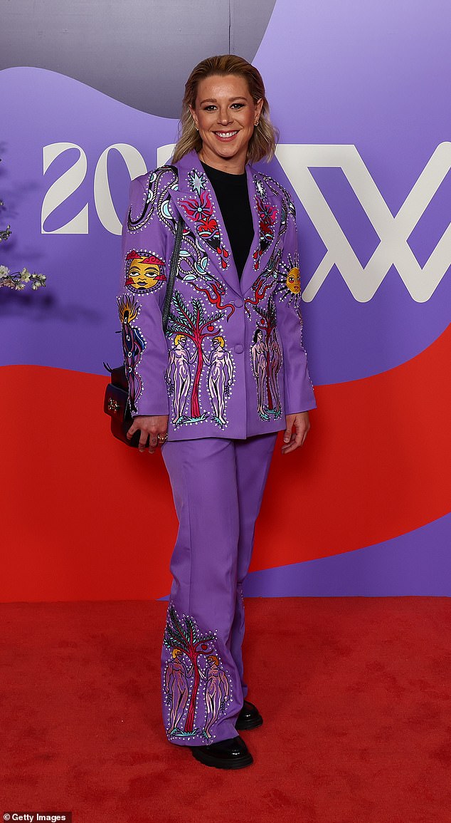 Brisbane Lions star Kate McCarthy stood out in a purple ensemble with a bright cartoonish print throughout