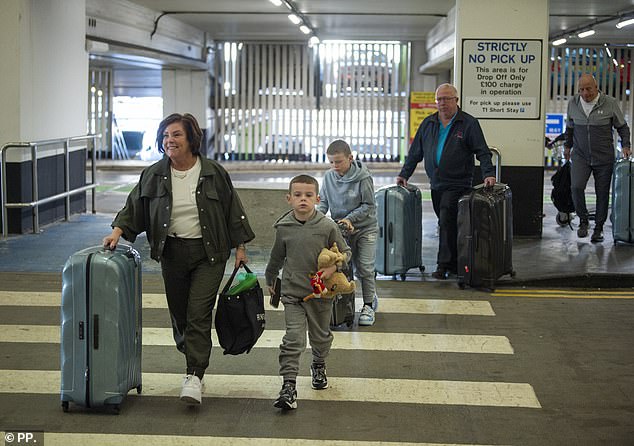 Coleen's mum flashed a huge smile as they arrived at the airport with Kit seen helping with the cases