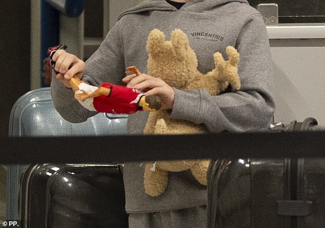 Coleen's youngest son Cass, six, was carrying a cuddly kangaroo as well as a figure of his father Wayne in a football kit as he arrived at check-in