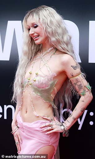 The singer was not afraid to flaunt both her racy and quirky sides, wearing a bizarre, barely there shell-inspired top with pearl and net embellishments draped over her slender and exposed torso