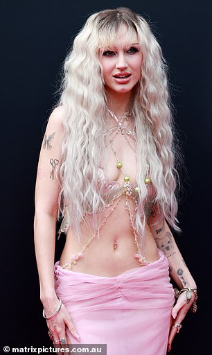 The singer was not afraid to flaunt both her racy and quirky sides, wearing a bizarre, barely there shell-inspired top with pearl and net embellishments draped over her slender and exposed torso