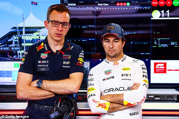ABU DHABI, UNITED ARAB EMIRATES - DECEMBER 08: Sergio Perez of Mexico and Oracle Red Bull Racing and race engineer Hugh Bird look on in the garage prior to the F1 Grand Prix of Abu Dhabi at Yas Marina Circuit on December 08, 2024 in Abu Dhabi, United Arab Emirates. (Photo by Mark Thompson/Getty Images)