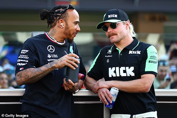 ABU DHABI, UNITED ARAB EMIRATES - DECEMBER 08: Lewis Hamilton of Great Britain and Mercedes and Valtteri Bottas of Finland and Stake F1 Team Kick Sauber talk on the drivers parade prior to the F1 Grand Prix of Abu Dhabi at Yas Marina Circuit on December 08, 2024 in Abu Dhabi, United Arab Emirates. (Photo by Joe Portlock/Getty Images)