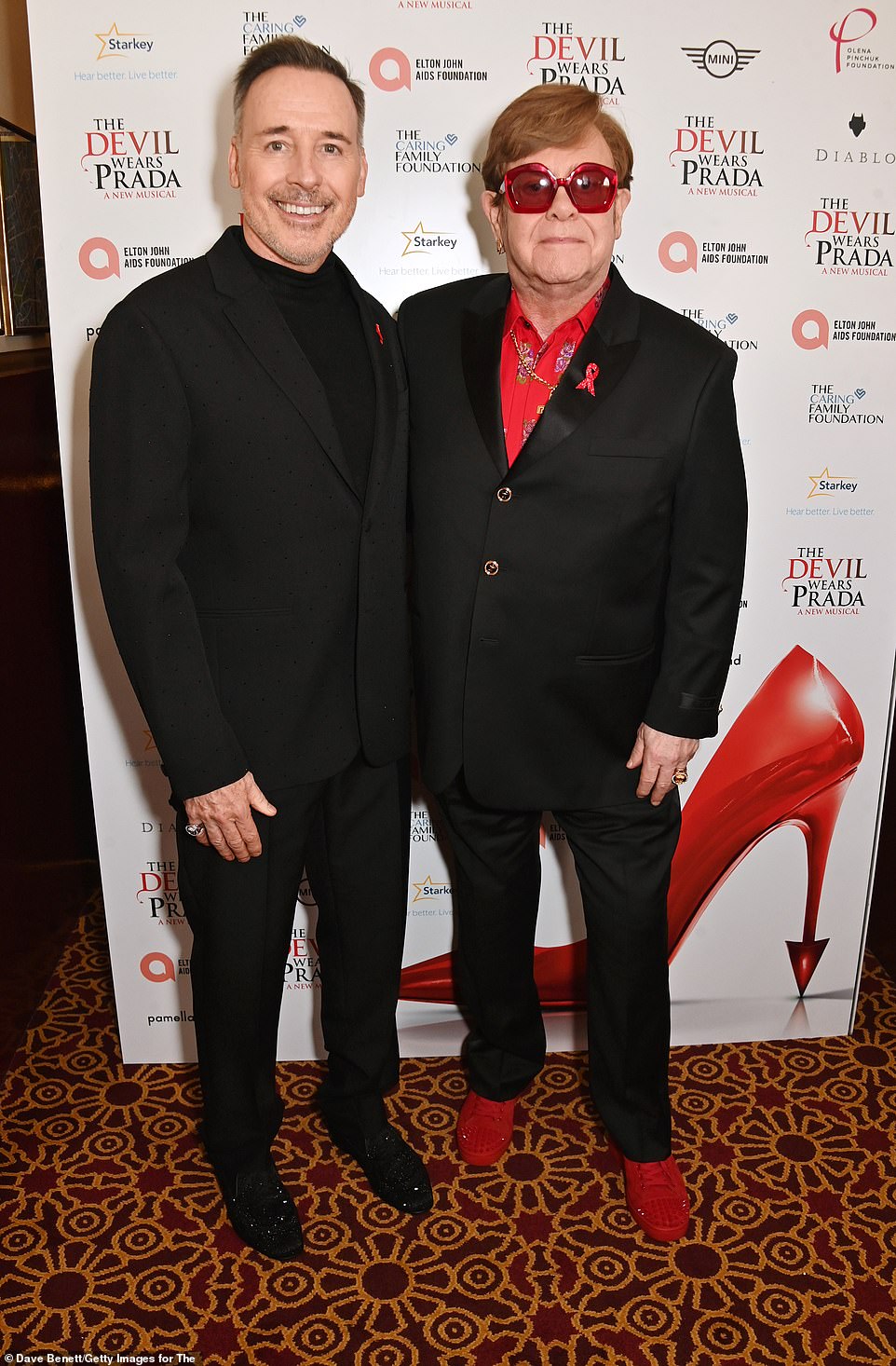 Elton's husband David Furnish, 62 (L) who also produces the show was also suited and booted