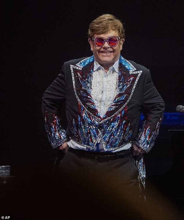 In one scene Sir Elton is seen apart from his family while touring the US and shares that he's leaving the road behind to 'dedicate more time to raising my children' (pictured 2023)