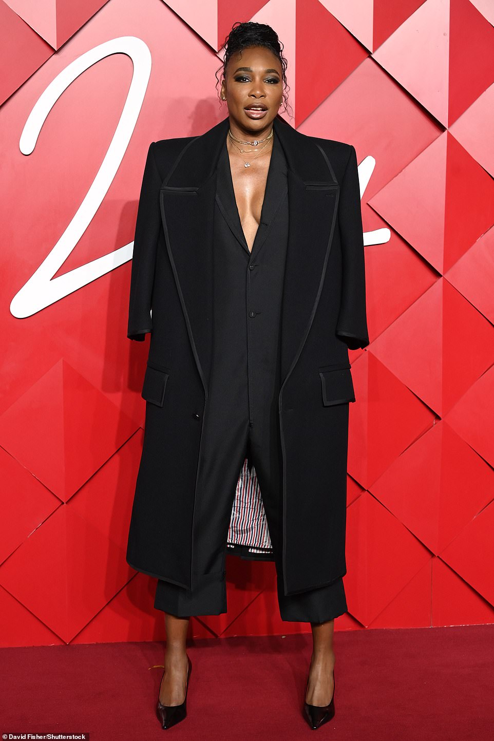 Venus Williams cut a sophisticated figure as she flashed her cleavage in a daring low cut black jumpsuit