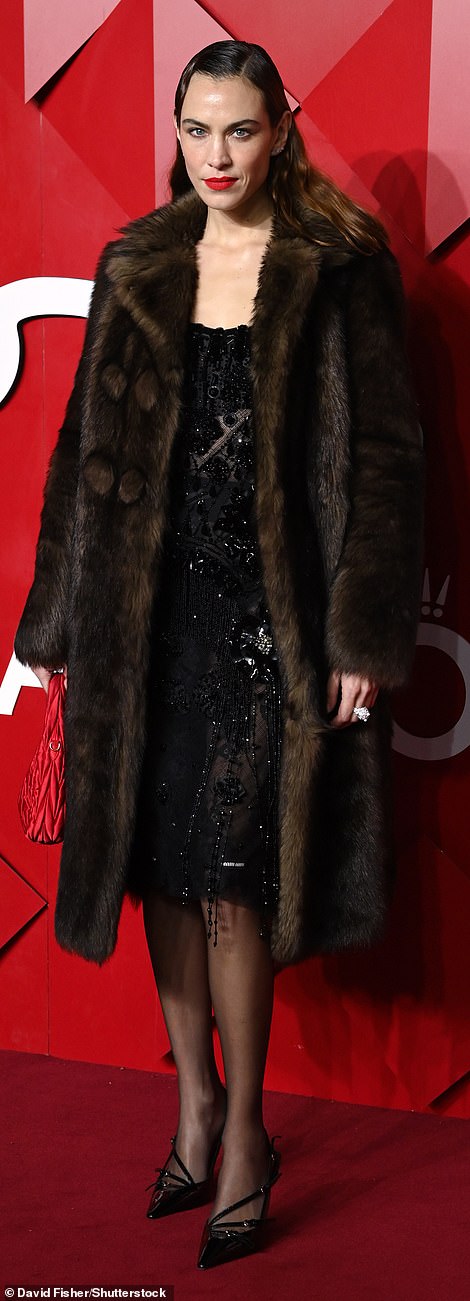 She accessorised the a red leather bag and bold red lip