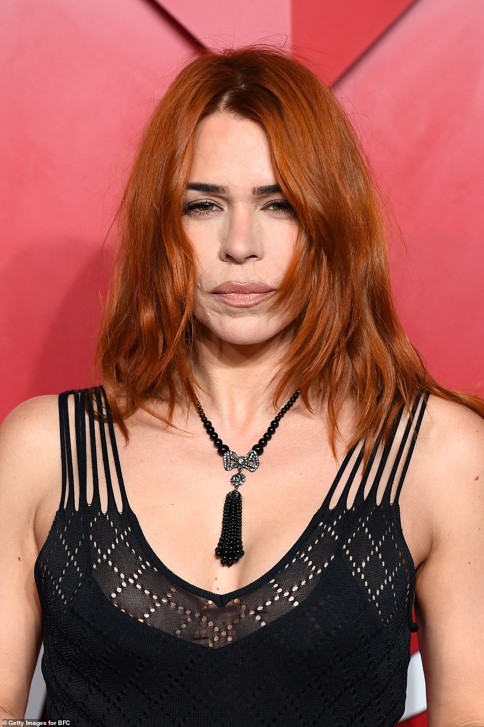The actress, 42, accessorised the look with a gothic black beaded necklace as she let her auburn locks fall naturally