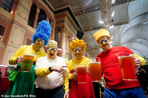 Fans dressed up as characters from "The Simpsons" during day fourteen of the Paddy Power World Darts Championship at Alexandra Palace, London. Picture date: Wednesday January 1, 2025. PA Photo. See PA story DARTS World. Photo credit should read: Zac Goodwin/PA Wire.RESTRICTIONS: Use subject to restrictions. Editorial use only, no commercial use without prior consent from rights holder.