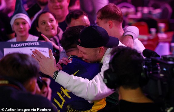 Darts - 2025 PDC World Darts Championship - Alexandra Palace, London, Britain - December 30, 2024 Luke Littler celebrates with Southampton's Aaron Ramsdale after winning his fourth round match against Ryan Joyce Action Images via Reuters/Andrew Boyers