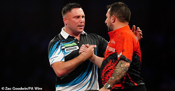 Gerwyn Price reacts after winning his fourth round match against Jonny Clayton (right) on day twelve of the Paddy Power World Darts Championship at Alexandra Palace, London. Picture date: Sunday December 29, 2024. PA Photo. See PA story DARTS World. Photo credit should read: Zac Goodwin/PA Wire.RESTRICTIONS: Use subject to restrictions. Editorial use only, no commercial use without prior consent from rights holder.