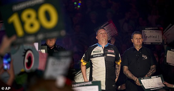 Chris Dobey of England arrives for his round 4 match against Kevin Doets of the Netherlands at the World Darts Championship in London, Monday, Dec. 30, 2024. (AP Photo/Alberto Pezzali)