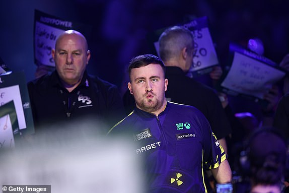 LONDON, ENGLAND - DECEMBER 30: Luke Littler of England looks on as he enters the arena prior to his fourth round match against Ryan Joyce of England on day thirteen of the 2024/25 Paddy Power World Darts Championship at Alexandra Palace on December 30, 2024 in London, England.  (Photo by James Fearn/Getty Images)