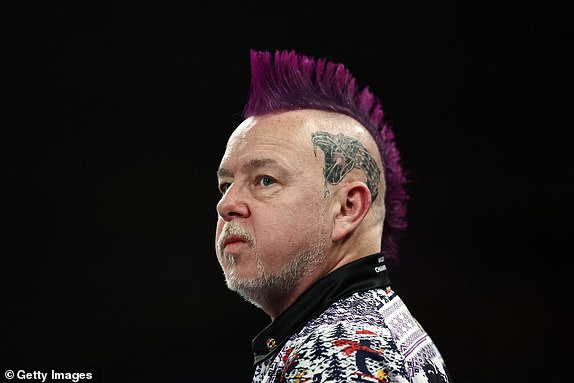 LONDON, ENGLAND - DECEMBER 29: Peter Wright of Scotland looks on against Luke Humphries of England during their fourth round match on day twelve of the 2024/25 Paddy Power World Darts Championship at Alexandra Palace on December 29, 2024 in London, England.  (Photo by James Fearn/Getty Images)