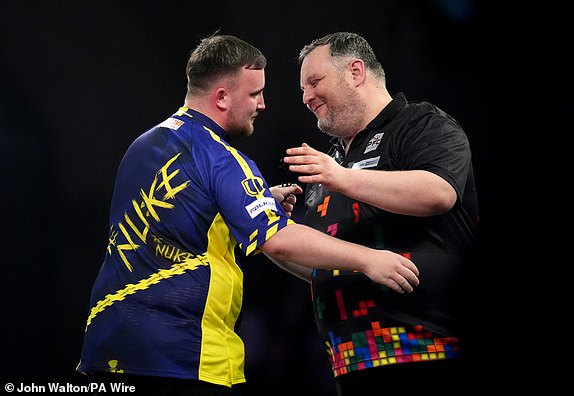 Luke Littler (left) is congratulated on his victory by Ryan Joyce during day thirteen of the Paddy Power World Darts Championship at Alexandra Palace, London. Picture date: Monday December 30, 2024. PA Photo. See PA story DARTS World. Photo credit should read: John Walton/PA Wire.RESTRICTIONS: Use subject to restrictions. Editorial use only, no commercial use without prior consent from rights holder.