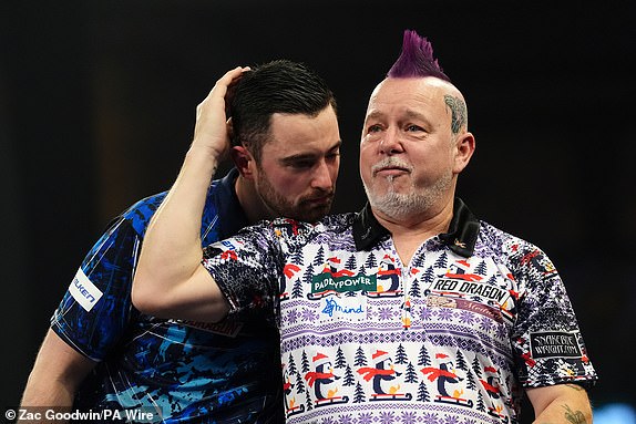 Peter Wright reacts after winning his fourth round match against Luke Humphries (left) on day twelve of the Paddy Power World Darts Championship at Alexandra Palace, London. Picture date: Sunday December 29, 2024. PA Photo. See PA story DARTS World. Photo credit should read: Zac Goodwin/PA Wire.RESTRICTIONS: Use subject to restrictions. Editorial use only, no commercial use without prior consent from rights holder.