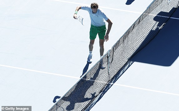 MELBOURNE, AUSTRALIA - JANUARY 14: Daniil Medvedev smashes a tv net camera installed on the net with his racket as he has lost the third set against Kasidit Samrej of Thailand in the Men's Singles First Round match during day three of the 2025 Australian Open at Melbourne Park on January 14, 2025 in Melbourne, Australia. (Photo by Darrian Traynor/Getty Images)