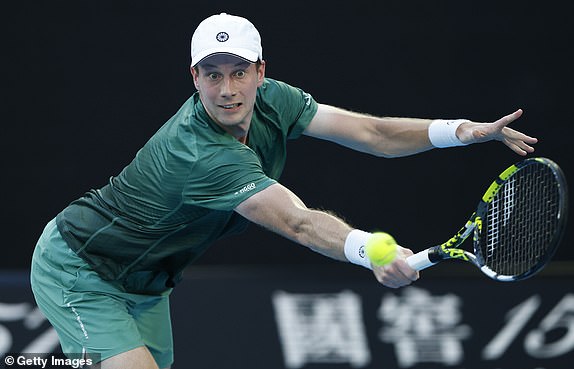 MELBOURNE, AUSTRALIA - JANUARY 14: Botic van de Zandschulp of the Netherlands plays a backhand against Alex de Minaur of Australia in the Men's Singles First Round match during day three of the 2025 Australian Open at Melbourne Park on January 14, 2025 in Melbourne, Australia. (Photo by Darrian Traynor/Getty Images)