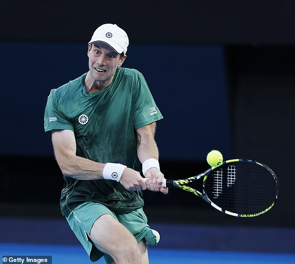 MELBOURNE, AUSTRALIA - JANUARY 14: Botic van de Zandschulp of the Netherlands plays a backhand against Alex de Minaur of Australia in the Men's Singles First Round match during day three of the 2025 Australian Open at Melbourne Park on January 14, 2025 in Melbourne, Australia. (Photo by Darrian Traynor/Getty Images)