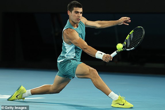 MELBOURNE, AUSTRALIA - JANUARY 21: Carlos Alcaraz of Spain plays a backhand against Novak Djokovic of Serbia in the Men's Singles Quarterfinal match during day 10 of the 2025 Australian Open at Melbourne Park on January 21, 2025 in Melbourne, Australia. (Photo by Clive Brunskill/Getty Images)