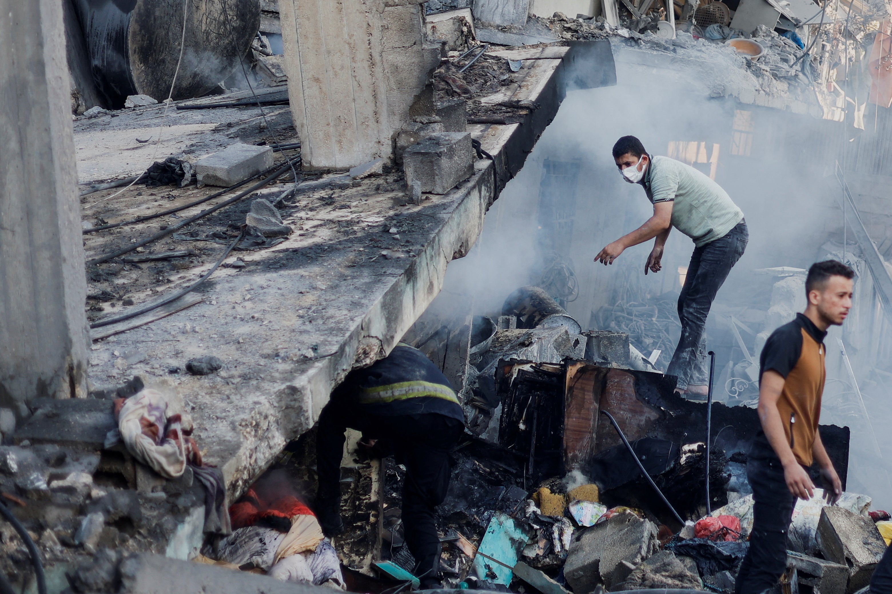 Palestinians search through rubble for casualties last year after Israel began launching airstrikes on Gaza following Hamas’s deadly 7 October attack