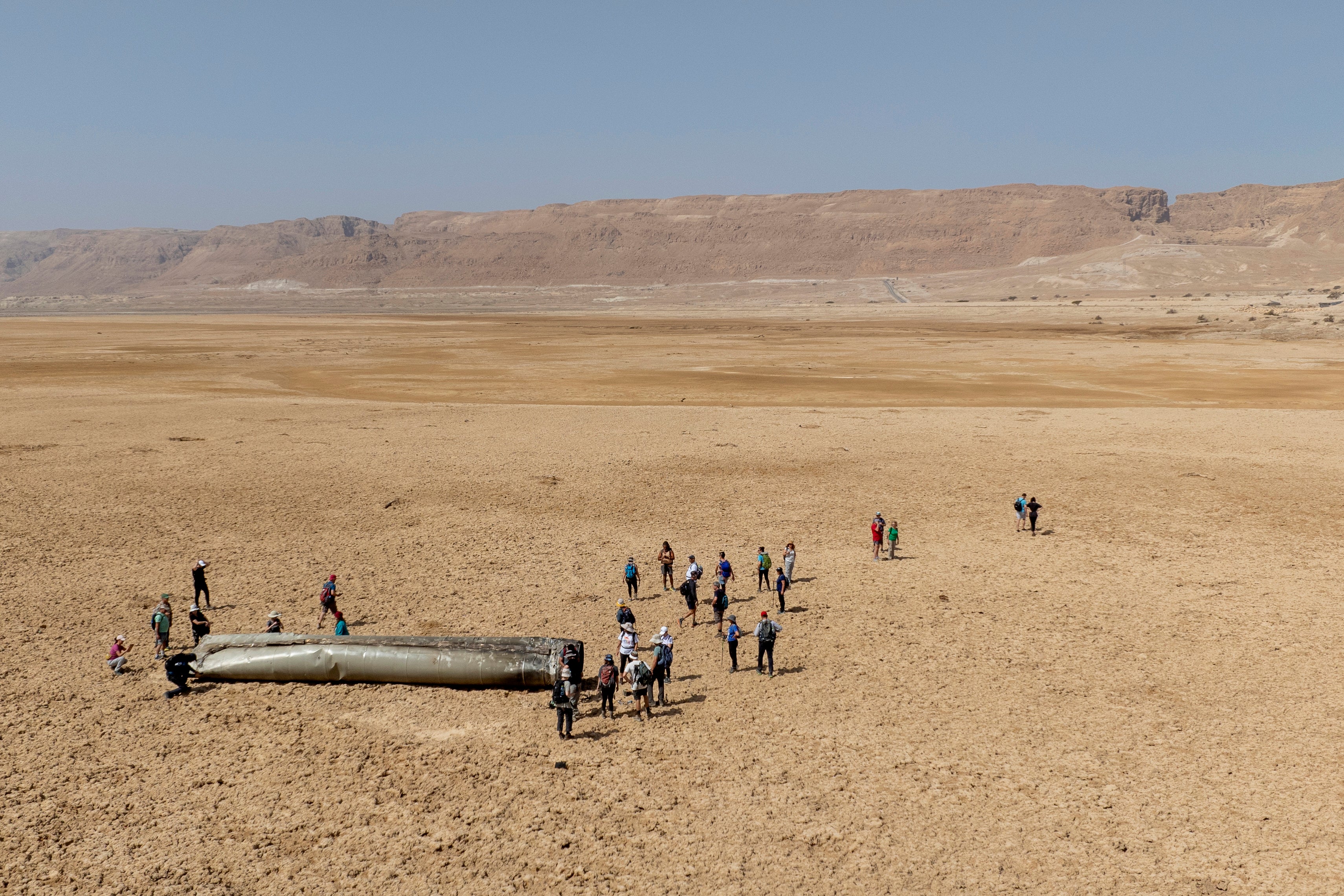 People gather around Iranian drone debris after Tehran launched a massive barrage at Israel in April