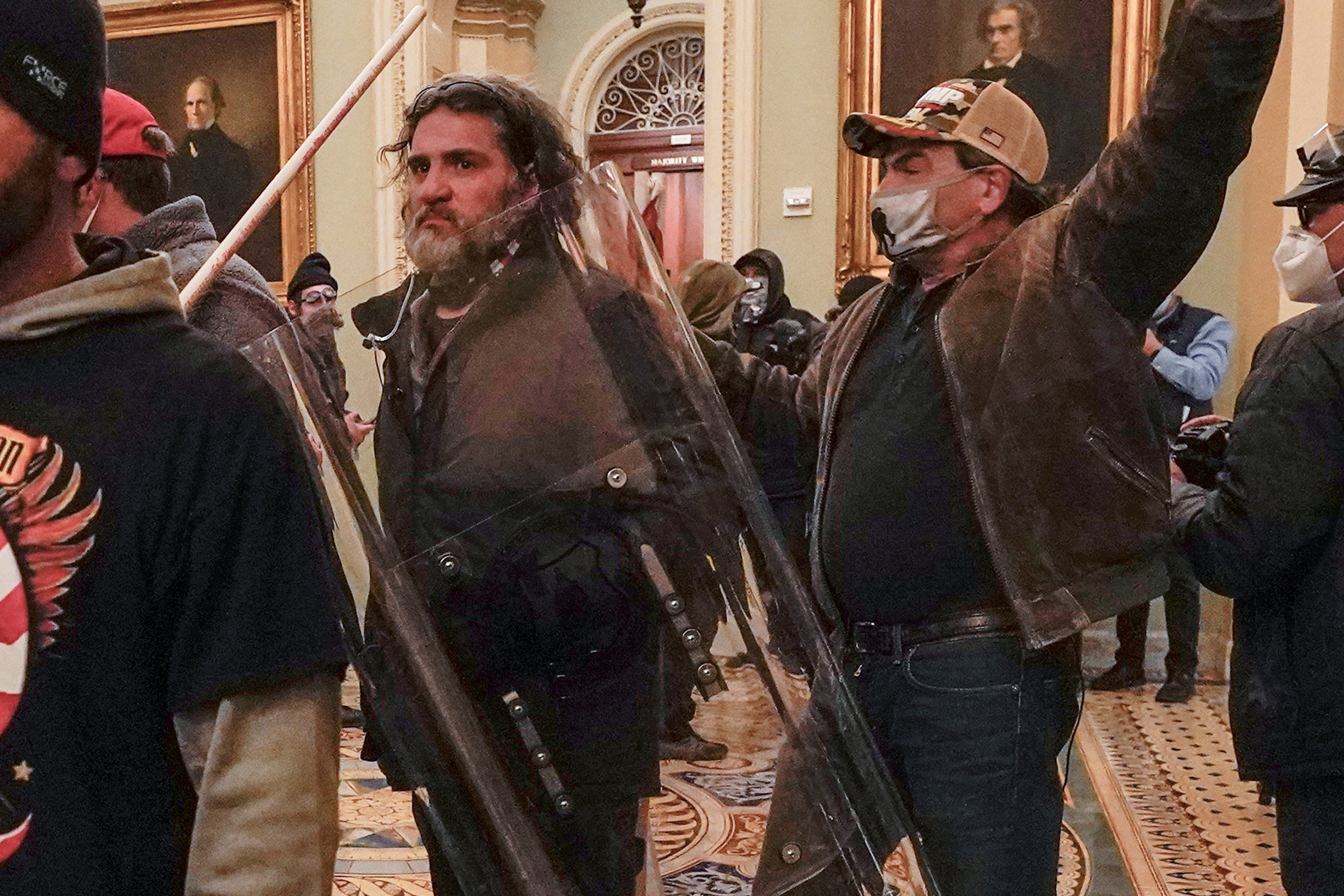 Dominic Pezzola, center with police shield, confronts Capitol Police officers outside the Senate chamber at the Capitol on January 6, 2021