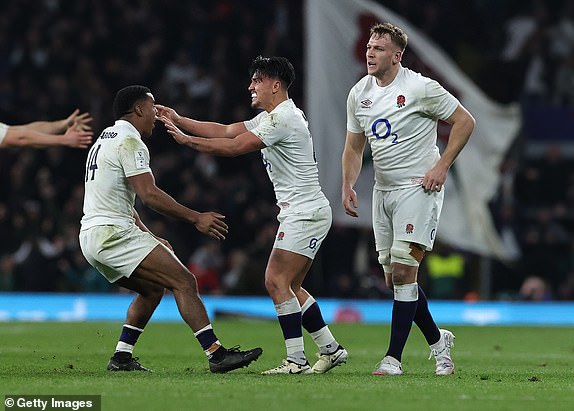 LONDON, ENGLAND - MARCH 09:  Marcus Smith of England celebrates with team mate Immanuel Feyi-Waboso after winning the match with a last minute drop goal during the Guinness Six Nations 2024 match between England and Ireland at Twickenham Stadium on March 09, 2024 in London, England. (Photo by David Rogers/Getty Images)