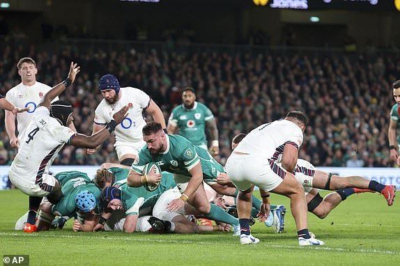 Ireland's Ronan Kelleher, center, goes through to score a try that was disallowed for a foul on England's Maro Itoje, left, during the Six Nations rugby union match between Ireland and England at the Aviva Stadium in Dublin, Saturday, Feb. 1, 2025. (AP Photo/Peter Morrison)