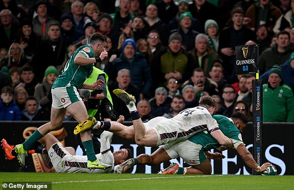 DUBLIN, IRELAND - FEBRUARY 01: Bundee Aki of Ireland scores his team's second try as he is tackled by Tommy Freeman of England during the Guinness Six Nations 2025 match between Ireland and England at Aviva Stadium on February 01, 2025 in Dublin, Ireland. (Photo by Charles McQuillan/Getty Images)