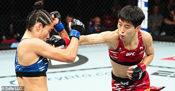 SYDNEY, AUSTRALIA - FEBRUARY 09: (R-L) Wang Cong of China punches Bruna Brasil of Brazil in a lightweight fight during the UFC 312 event at Qudos Bank Arena on February 09, 2025 in Sydney, Australia.  (Photo by Jeff Bottari/Zuffa LLC)