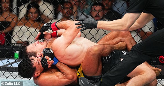 SYDNEY, AUSTRALIA - FEBRUARY 09: (L-R) Gabriel Santos of Brazil secures a rear choke submission against Jack Jenkins of Australia in a featherweight fight during the UFC 312 event at Qudos Bank Arena on February 09, 2025 in Sydney, Australia.  (Photo by Jeff Bottari/Zuffa LLC)
